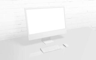 White computer display on work desk with brick wall in background. Isolated screen for mockup, app or web page presentation photo