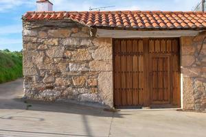 old stone house with wooden door photo