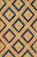 Pattern of gold flower carved on stucco design of native wall, Thai style in temple photo