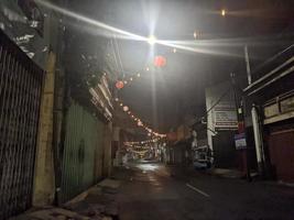 a street at night with lanterns lit up in surabaya, indonesia photo