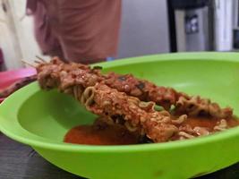 A sate usus balado or balado intestinal satay. Delicious indonesian food. For food background or wallpaper photo