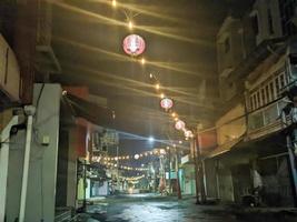 a street at night with lanterns lit up in surabaya, indonesia photo