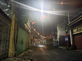 a street at night with lanterns lit up in surabaya, indonesia photo