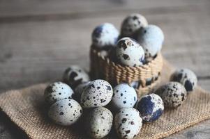 quail eggs on basket, fresh quail eggs on wooden table background, raw eggs with peel egg shell photo
