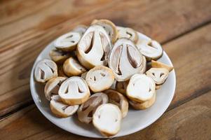 straw mushrooms on white plate, fresh mushrooms slice for cooking food photo