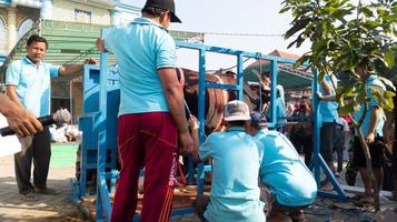 gresik, indonesia, june 2022 - people who are working together to carry out qurbani during Eid al-Adha photo