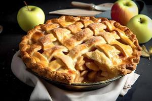 A pie with a lattice crust sits on a table next to a basket of apples photo