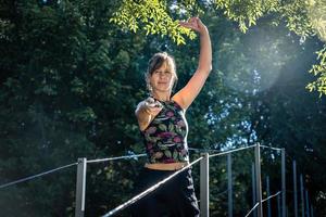 Woman practising tai chi with a sword on a bridge. photo