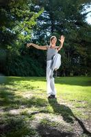 Tai Chi master woman practicing the activity for holding balance. photo