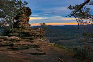 Sandstone formation in the forest during sunset photo