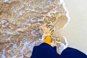 Walking barefoot on the beach sand by the water Mexico. photo