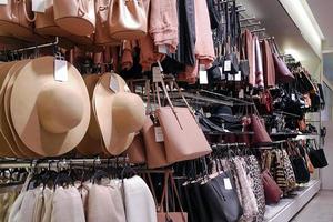 Women hats and bags in accessories shop photo