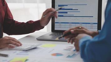 Financial analysts analyze business financial reports on a digital tablet planning investment project during a discussion at a meeting of corporate showing the results of their successful teamwork. video