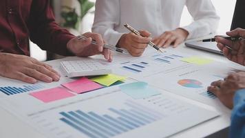 Financial analysts analyze business financial reports on a digital tablet planning investment project during a discussion at a meeting of corporate showing the results of their successful teamwork. video