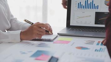 Financial analysts analyze business financial reports on a digital tablet planning investment project during a discussion at a meeting of corporate showing the results of their successful teamwork. video