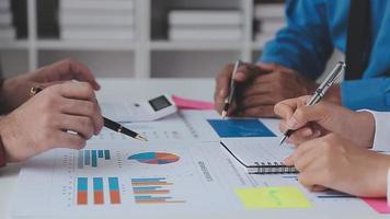 Financial analysts analyze business financial reports on a digital tablet planning investment project during a discussion at a meeting of corporate showing the results of their successful teamwork. video