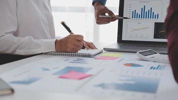 Financial analysts analyze business financial reports on a digital tablet planning investment project during a discussion at a meeting of corporate showing the results of their successful teamwork. video