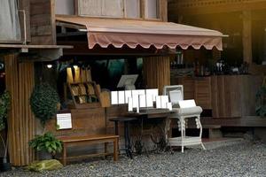 coffee shop fronts the design is vintage style. There is a counter for taking orders, making payments, placing signs to introduce various menus. and give customers a queue with a computer system. photo