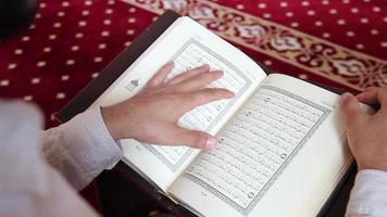 young muslim reading quran in mosque video