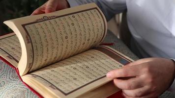 The view of the opening of the cover of the Quran standing on the table and the pages, the image of a religious book with the Arabic alphabet video