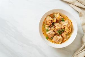 pork wonton soup or pork dumplings soup with roasted chili photo