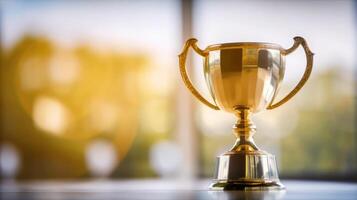 Gold trophy on table and blurry bokeh background photo