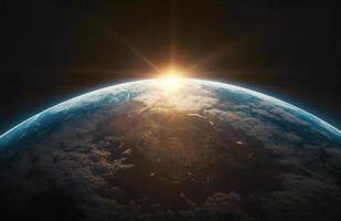 Nightly Earth planet in outer space with sun flare photo