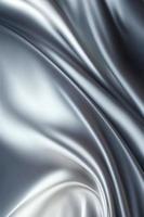 Silver silk wavy fabric background photo