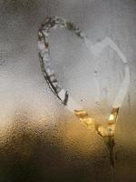 A love heart painted on a misted glass window background photo