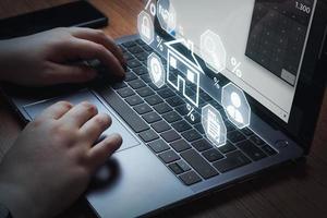 Home mortgage loan concept. Woman using laptop to apply for a Mortgage loan with digital interface. Contract for hire purchase and sale a house. photo