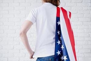 White polo shirt on woman over USA flag background, mockup design photo