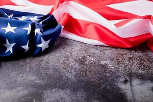 Closeup of American flag on dark cement background photo