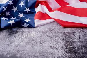 Closeup of American flag on dark cement background photo