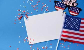 Blank white frame for mockup design on American national flag blue background with decorations photo