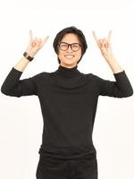 Showing Metal Hand Sign Of Handsome Asian Man Isolated On White Background photo