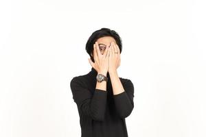 Shocked Covering Face and Peep Between the fingers Of Handsome Asian Man Isolated On White photo