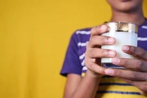 boy holding a glass of milk with copy space photo