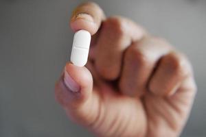 Close up of man hand holding pills with copy space photo