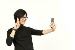 Take a Selfie using Smartphone Of Handsome Asian Man Isolated On White Background photo