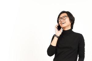 hacer un teléfono llamada utilizando teléfono inteligente con sonrisa cara de hermoso asiático hombre aislado en blanco foto