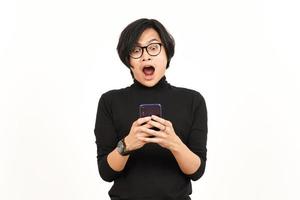 Holding and Using Smartphone With Shocked Face Of Handsome Asian Man Isolated On White Background photo