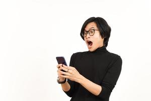 Holding and Using Smartphone With Shocked Face Of Handsome Asian Man Isolated On White Background photo