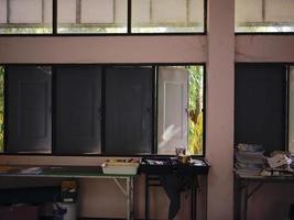 The THAIALND antique wooden classroom with old style desks . photo