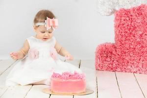 First birthday. Baby one year old. Beautiful little girl with a birthday cake. photo