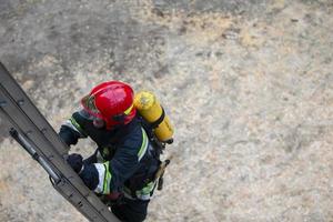 Firefighter climbs the stairs. Lifeguard training. photo