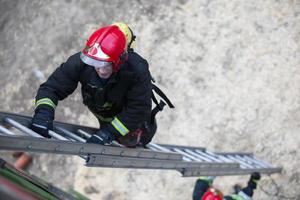 Firefighter climbs the stairs. Lifeguard training. photo