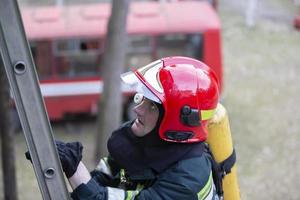 Fire base. Firefighter climbs the stairs. photo