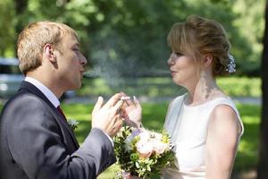 The bride and groom smoke. Young with cigarettes photo