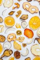 Dried fruits isolated on white background. Healthy eating concept. Top view. Healthy vegetarian food concept. Dried fruit chips. photo