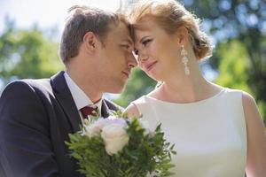 Beautiful bride and groom. Lovers. Newlyweds with a bouquet. photo